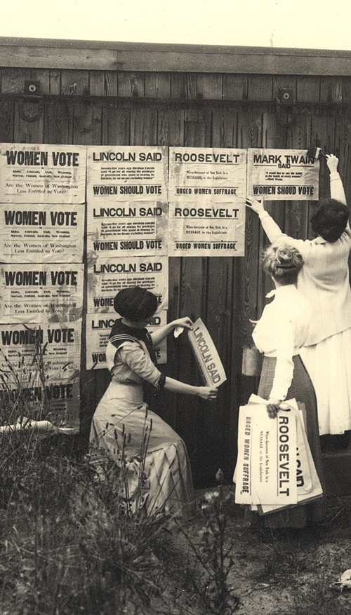 Suffragists hang posters